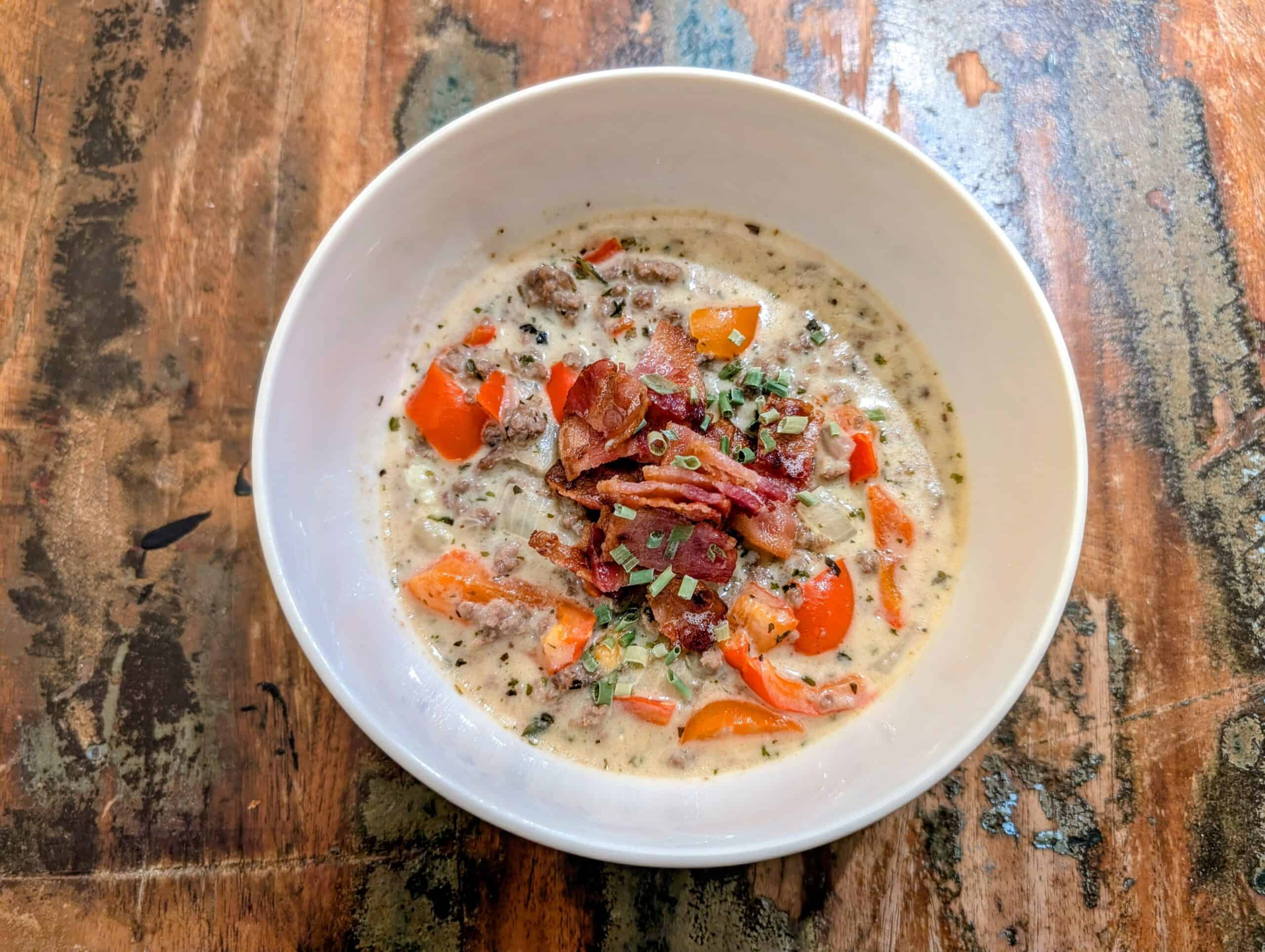 Bowl of Philly Cheeseburger Soup, beef, cheese, roux, peppers onions and spices