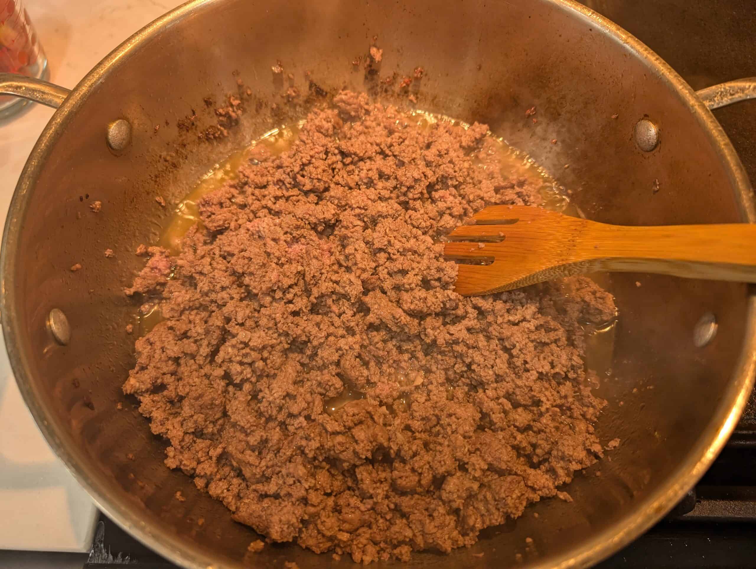 Cooked ground beef in a stainless steel sauce pan 