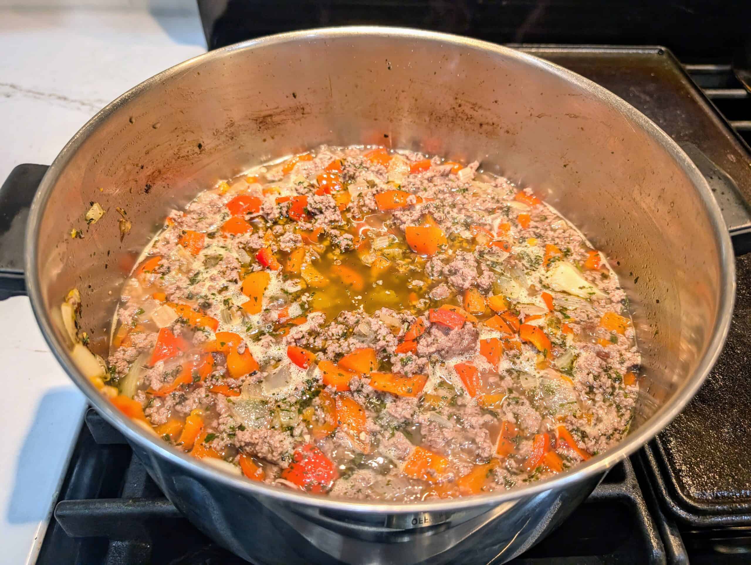 Base of my soup, ground beef, peppers, onions, parsley, basil, salt, pepper and chicken broth. 