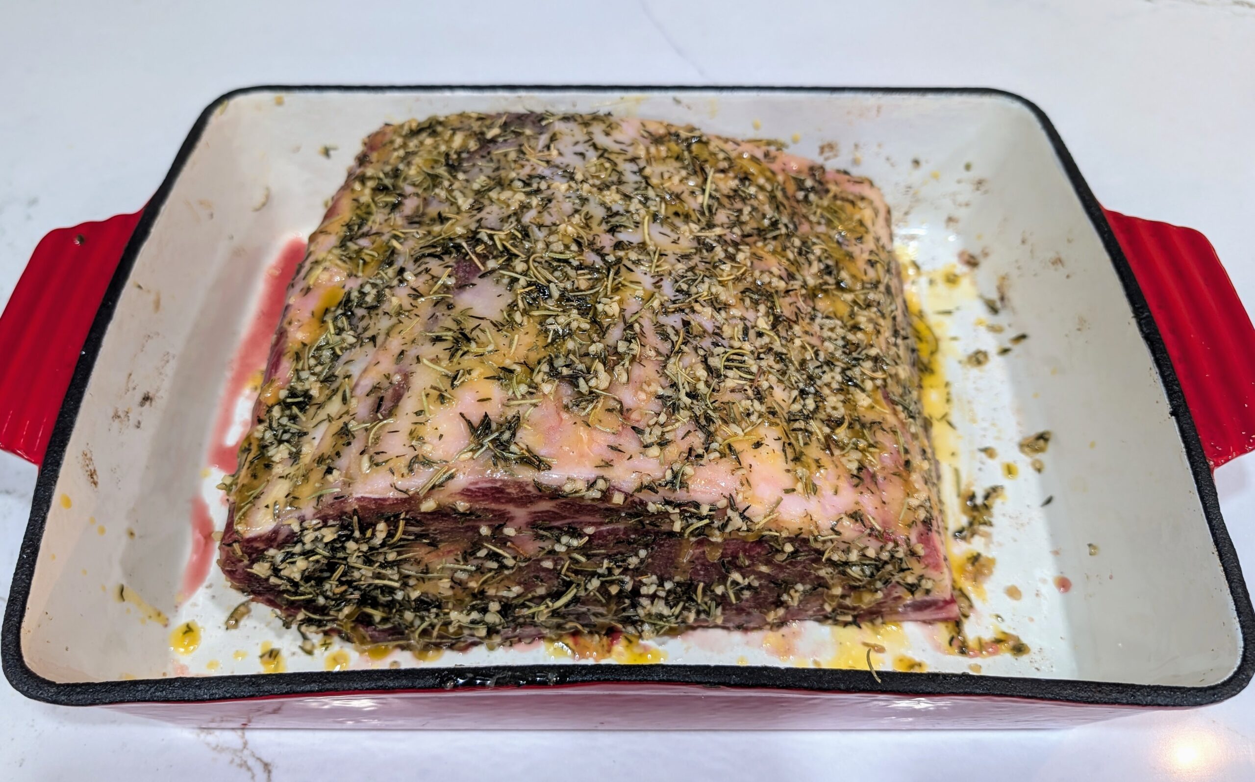 Ribeye roast covered in butter and spices