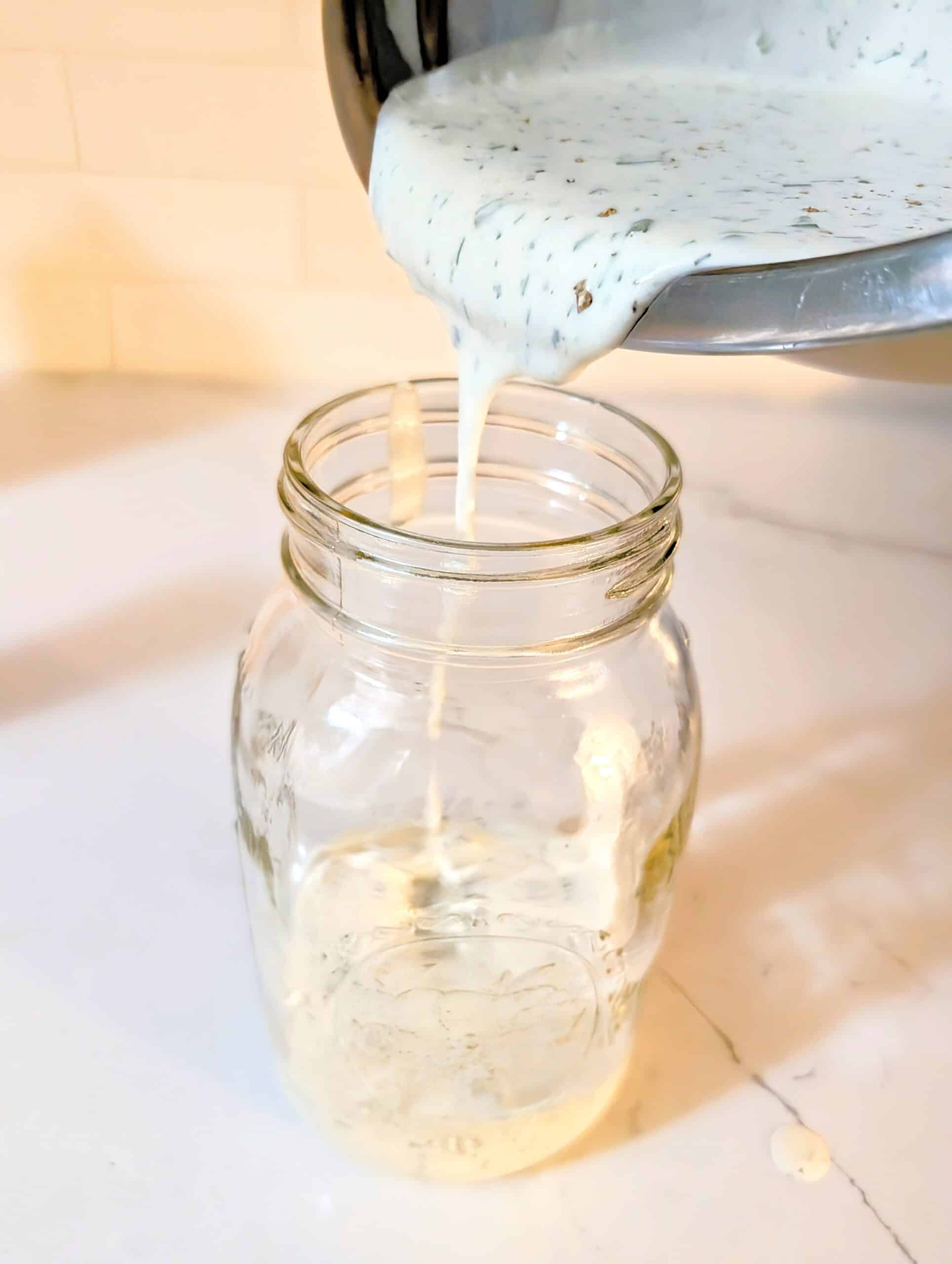 Pouring dipping sauce into the mason jar 